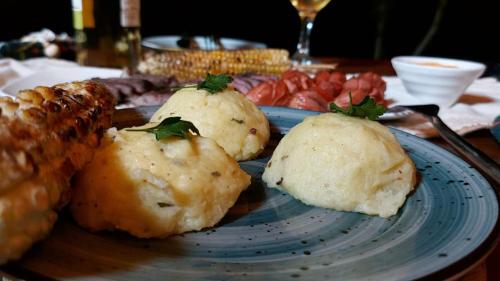 a plate of food with biscuits and meat on a table at Ella Nine Peaks in Ella