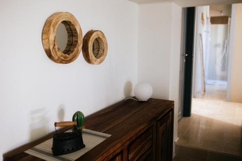 a room with a wooden table and two mirrors on the wall at Borgo Chiancarosa in Putignano