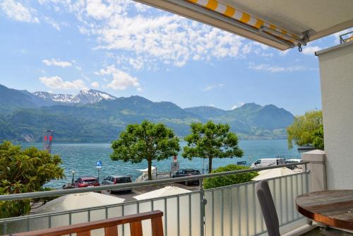 a balcony with a view of a lake and mountains at Seehotel Riviera at Lake Lucerne in Gersau