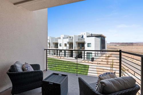 a balcony with chairs and a view of a house at Anchor Oasis #87 condo in St. George