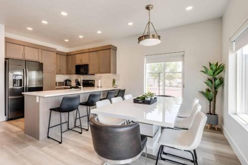 a kitchen with a white table and chairs at Family Retreat at the Vue #15 townhouse in St. George