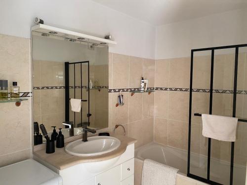 une salle de bain avec un lavabo, une douche et une baignoire dans l'établissement BIKINI, à Cavalaire-sur-Mer