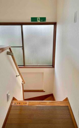 an empty room with a staircase and a window at 雅 南熱海 温泉別荘 Ocean View Hotspring Villa in Ajiro