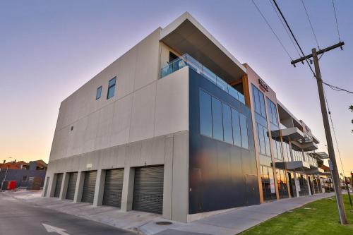 a large building with large windows on a street at Indulge Apartments - City View Penthouses in Mildura