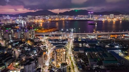 a city lit up at night with a bridge at Yeongdo Grandbern Hotel in Busan