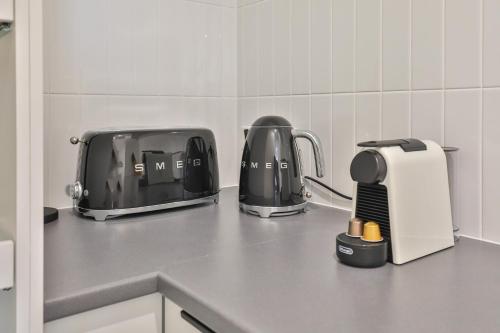 a kitchen counter with two toasters and a toaster at Indulge Apartments - City View Penthouses in Mildura