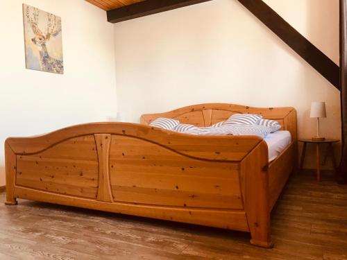 a large wooden bed in a corner of a room at Ferienhaus Geiger in Bernau im Schwarzwald in Bernau im Schwarzwald