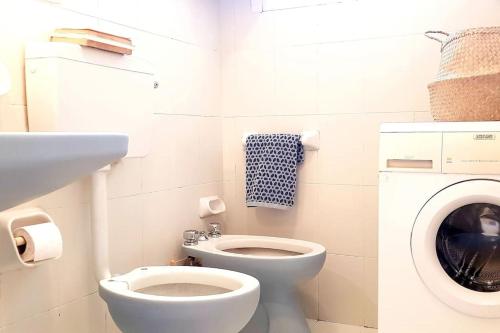 a bathroom with a toilet and a washing machine at Vita in Catania