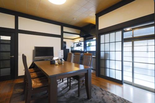 a dining room with a table and chairs at Isumi Resonal Ohara in Isumi