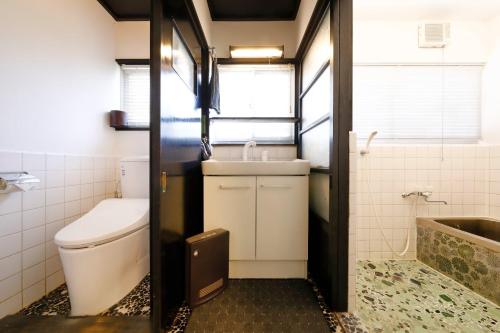 a small bathroom with a toilet and a sink at Isumi Resonal Ohara in Isumi