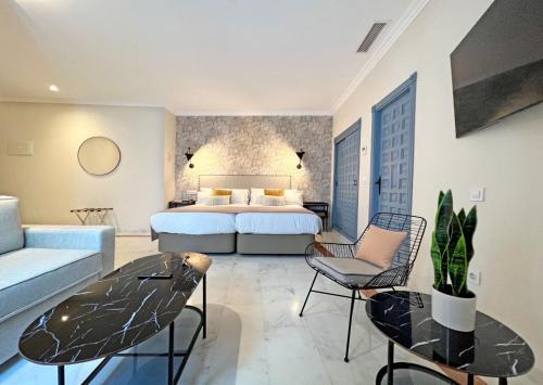 a hotel room with a bed and a couch at Itaca Sevilla by Soho Boutique in Seville