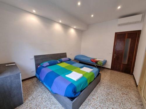 a bedroom with a bed with a colorful comforter at Casa D&D in Alassio