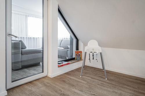 a mirror in a room with a chair and a couch at Luxurious apartment in the heart of Poprad in Poprad