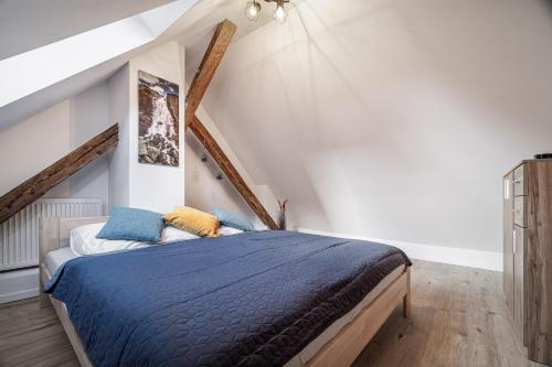 a bedroom with a bed with a blue comforter at Luxurious apartment in the heart of Poprad in Poprad