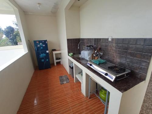 a kitchen with a sink and a counter top at RD Cottage Valley in Bogor