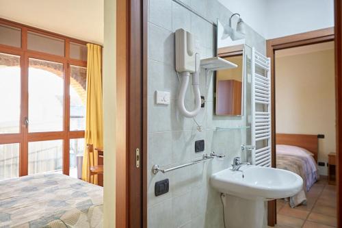 a bathroom with a sink and a phone in a room at Al Casale B&B in Cherasco