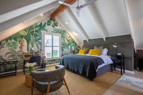 a bedroom with a large bed and tropical wallpaper at Dornoch on Gowrie Farm, Nottingham Road in Nottingham Road