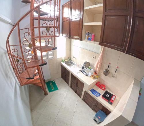 an overhead view of a kitchen with a spiral staircase at JE Homestay Jogja in Sentool