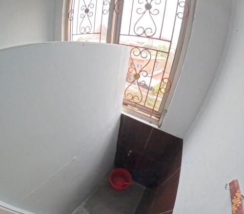 a stairway with a window and a red bowl at JE Homestay Jogja in Sentool