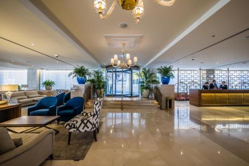 a lobby of a hotel with couches and chairs at Herbert Samuel Jerusalem in Jerusalem