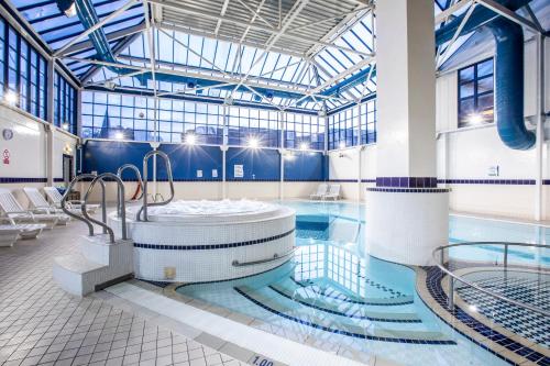a pool with a hot tub in a building at Holiday Inn London Sutton by IHG in Sutton