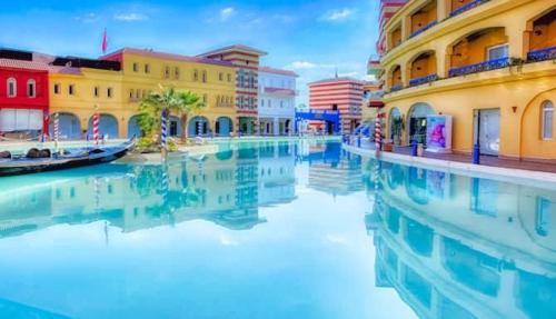 a group of buildings next to a body of water at porto marina panoramica sea view in El Alamein