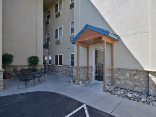 a patio outside of a building with a table and chairs at Yellowstone West Gate Hotel in West Yellowstone
