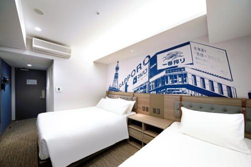 a hotel room with two beds and a sign on the wall at Travelodge Sapporo Susukino in Sapporo