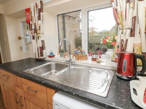 a kitchen counter with a sink and a window at Miller's Retreat in Alnwick