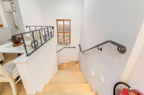 a staircase in a home with white walls and wooden floors at Farm Stay Ivankotovi in Prem