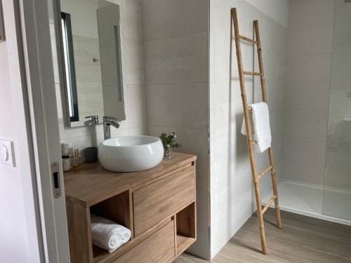 a bathroom with a sink and a mirror at La Sté in Porticcio