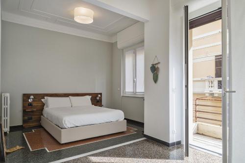 a bedroom with a bed and a sliding glass door at Beauty & Design in the Center by Wonderful Italy in Genova