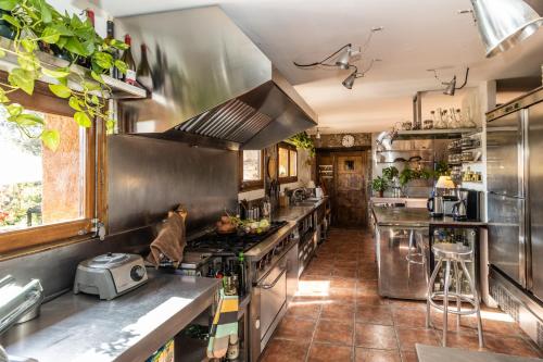 a large kitchen with stainless steel appliances at El Querol Vell in Borredá