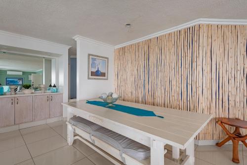 a dining room with a table and a kitchen at CAPRI 15 in Margate