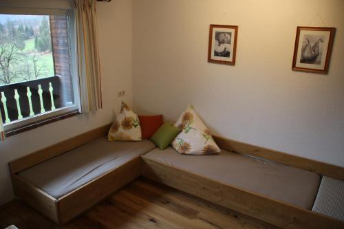 a bench with pillows on it in a room with a window at Haus Stangl in Bad Aussee