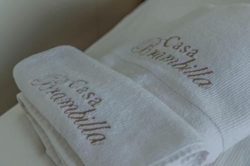 a pair of white towels sitting on a bed at Casa Brambilla in Cissano
