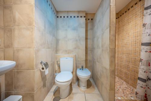 uma casa de banho com um WC e um lavatório em Beautiful Parque Loix 4 bedroom apartment shared pool, tennis court em Benidorm
