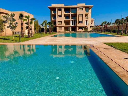 a large swimming pool in front of a building at Wonderful Apartment in the best area of ​​Marrakech in Marrakech