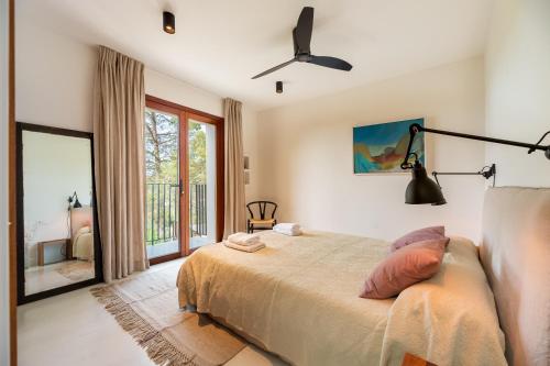 1 dormitorio con 1 cama y ventilador de techo en Casa Juliarina en San Jose de sa Talaia