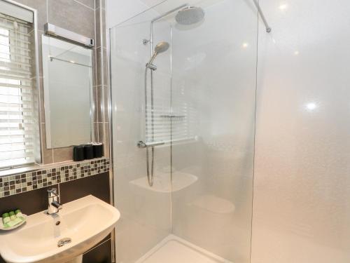 a bathroom with a shower and a sink at Barnstead in Pooley Bridge