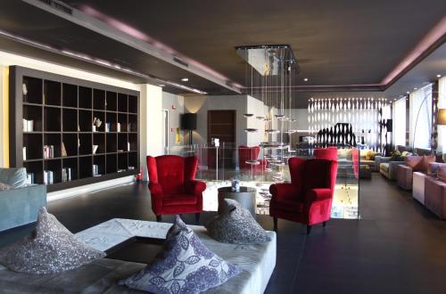 a living room with red chairs and a couch at c-hotels Ambasciatori in Florence
