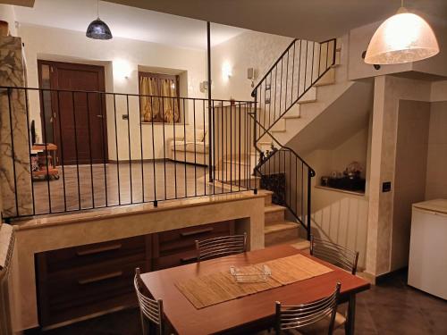 comedor con mesa y escalera en Il palazzetto "fori porta" en Vitorchiano