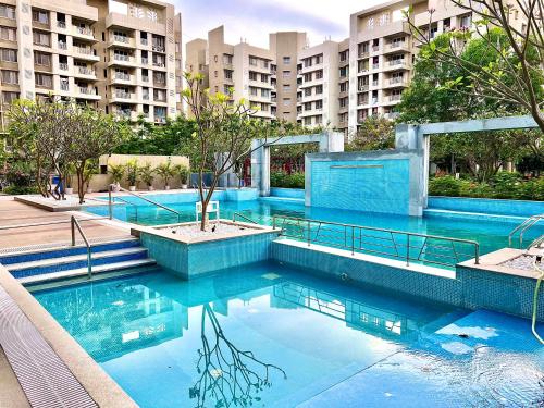 a swimming pool with blue water in front of a building at 2BHK luxurious beautiful flat near IIM AIIMS in Nagpur