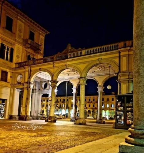 a large building with a large archway at night at I Portici guest house in Alessandria