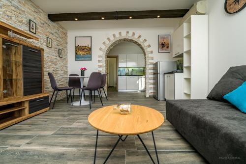 a living room with a couch and a table at Villa Magnolia in Mali Lošinj