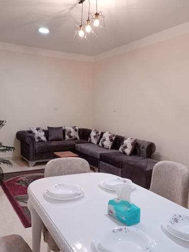 a living room with a white table and a couch at cozy apartment Aircon Downtown Aswan in Aswan