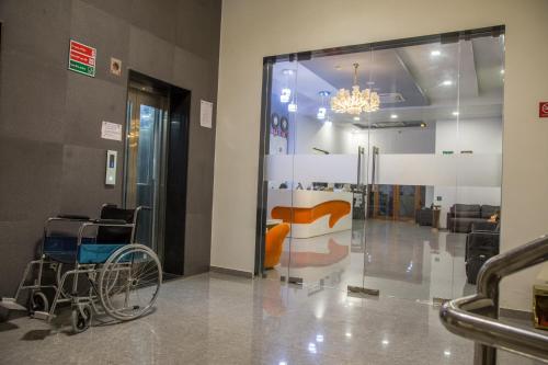 a lobby with a waiting room with a chair and a glass door at Vadpadraka Hotel And Resort in Vadodara