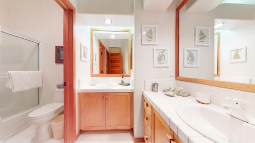 a bathroom with a sink and a toilet and a mirror at Snowcreek #760 condo in Mammoth Lakes