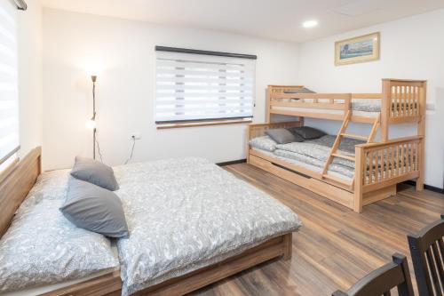 a bedroom with two bunk beds and a desk at Vila Máchovka in Nová Paka