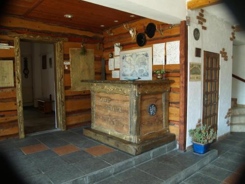 a room with a large wooden fireplace in a house at Predeal Club in Predeal